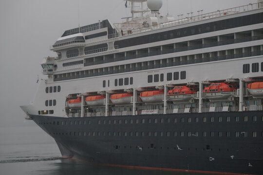 Classic luxury cruiseship cruise ship liner Zaandam Volendam arrival to Vancouver, BC after Alaska wilderness adventure Last frontier landscape nature scenery cruising with low hanging clouds misty
