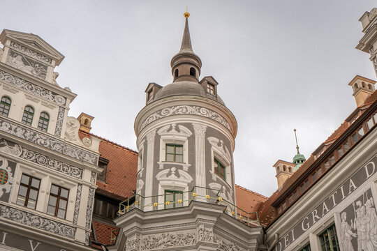 Corner tower of Dresden heritage building with sgraffito patterns and window surrounds, ornamental plasterwork, traditional renaissance-era architecture