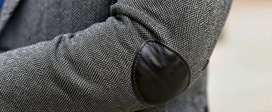 Captures Close View Of Persons Arm Focusing On Elbow Area Main Subject Wearing Herringbone Patterned Suit Jacket Primarily Black White