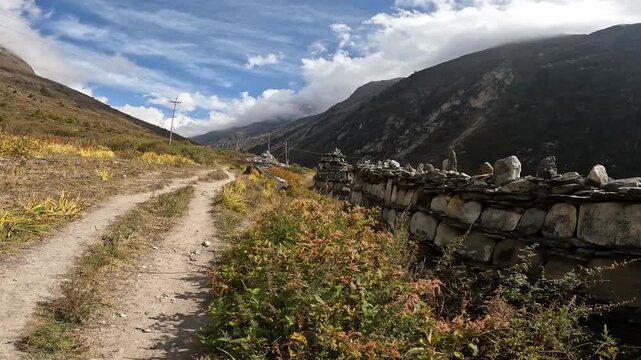 The Mani walls can be seen on the way to old Langtang village in Langtang valley, Nepal. This rock created as a form of devotional practice, piety, and virtue in Tibetan Buddhism.