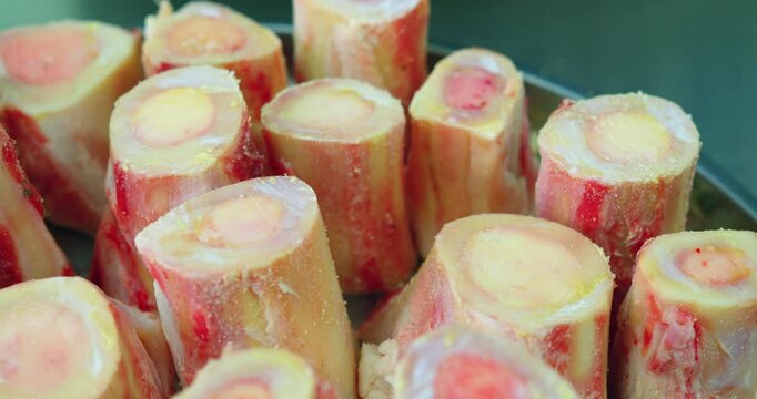 Marrow bones for pilaf in metal tray, close-up