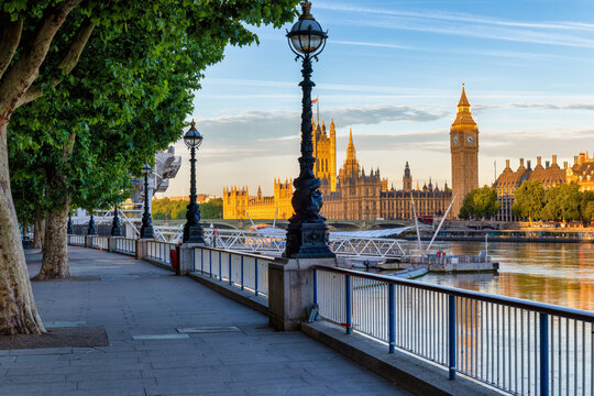 The London riverside of the Thames at Southbank with view of the Big Ben clocktower and Westminster Palace during a summer sunrise without people, United Kingdom