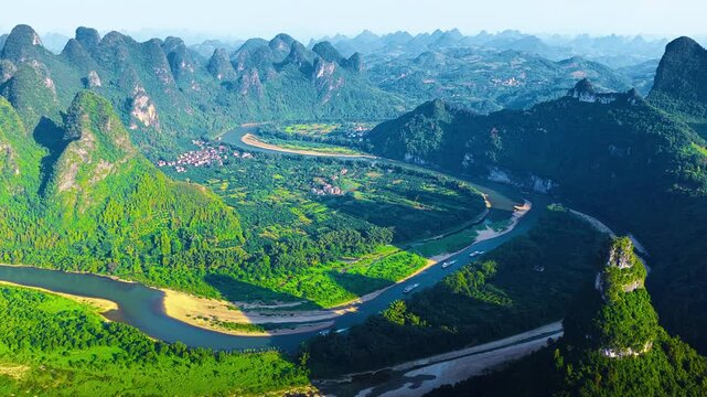 High angle view captures the winding Li River flowing through lush karst mountains near Xianggong Mountain in Guilin, Guangxi.
