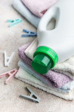 Laundry detergent bottle on a stack of clean towels