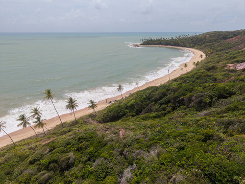 Beautiful aerial view to people on top of cliff over Coqueirinho