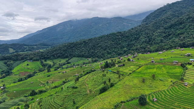 Aerial landscape view of rice terrace and wooden huts in the mountains