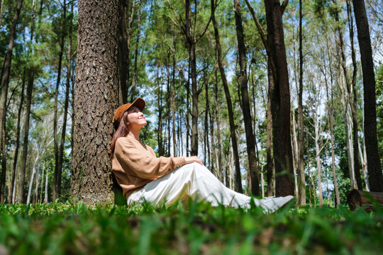 Portrait image of a woman sitting and relaxing in the park