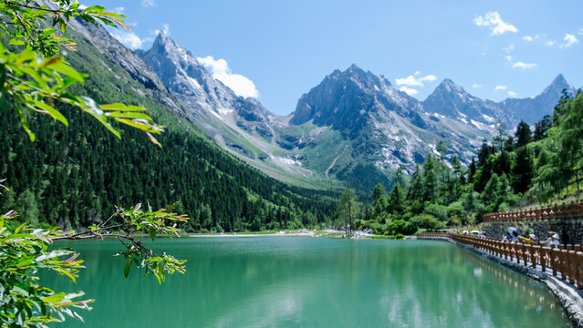 Landscape of the lake and greenery forest with four girls mountain range in Bipenggou, Chengdu China