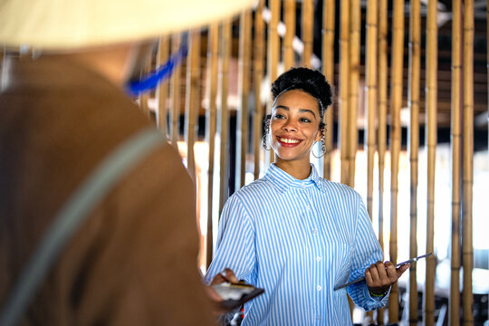 Smiling american business woman standing for portrait in coworking office workplace