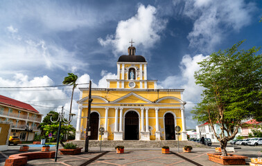 Fototapeta premium Facade of the Notre-Dame-de-l'Assomption church under a cloudy sky in Grand-Bourg, Marie-Galante Island, Guadeloupe, Caribbean France