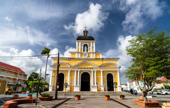 Facade of the Notre-Dame-de-l'Assomption church under a cloudy sky in Grand-Bourg, Marie-Galante Island, Guadeloupe, Caribbean France