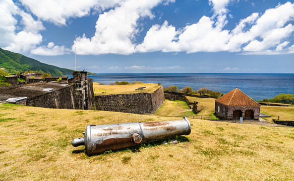Historic Fort Delgres featuring an ancient cannon, stone bastions, and coastal scenery in Basse-Terre, Guadeloupe.