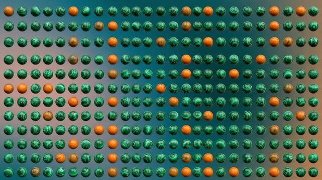 Polished green malachite and orange jasper spheres arranged in perfect geometric pattern creating an appealing visual grid.
