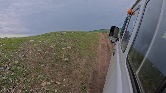 Old van driving along the bumpy road in Mongolia