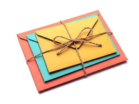 Stacked colorful envelopes tied with twine string isolated on transparent background.