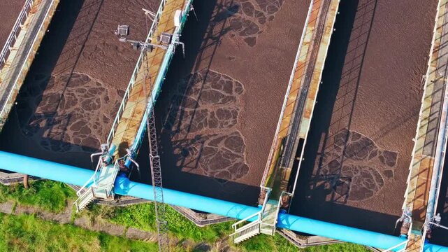 Brown wastewater bubbles through aeration basins at a plant in Liepaja