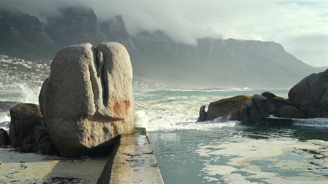 Atlantic sea tidal pool with misty mountains
