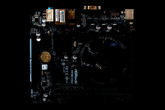 Detailed close-up of a dark printed circuit board featuring branded microchips, components, and the ASRock H81M-VG4 model marking.