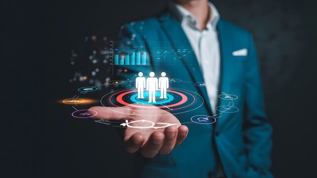 Businessman holding virtual holographic team icon in hand representing human resource management and professional business concept