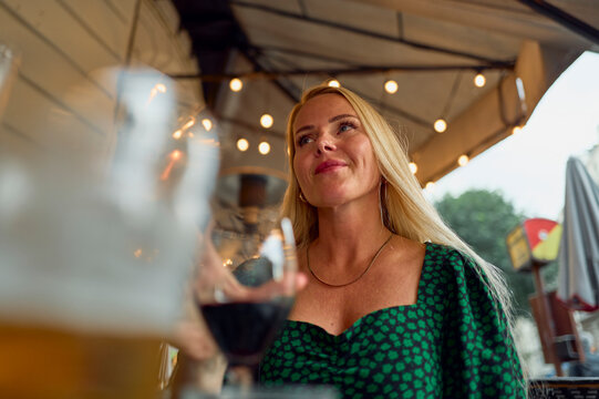 A beautiful blonde woman enjoying an evening date outdoors