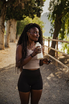 Fit young woman taking a break on a walk