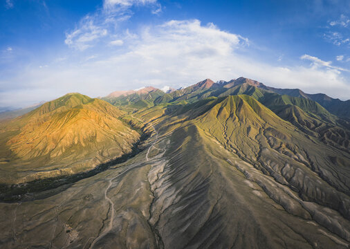 Expansive aerial view of a green mountain range