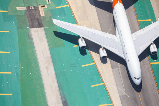Aerial view of large passenger jet on airport tarmac