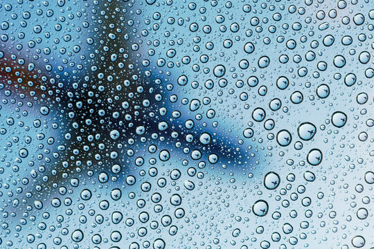 An airplane is reflected in many water drops