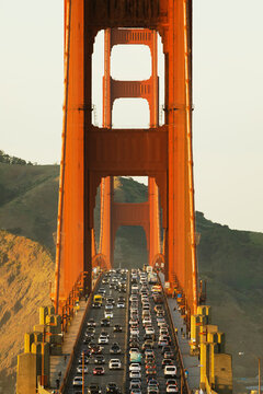 Cars in heavy traffic on the Golden Gate Bridge at sunset