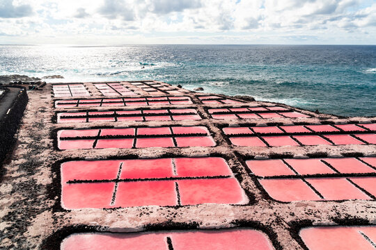 Striking pink salt evaporation ponds on a volcanic coast, Fuencaliente