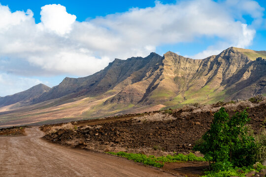 Winding dirt road through volcanic mountains in Fuerteventura
