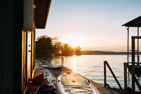 Paddleboards On Lakeside Dock During Autumn Sunrise