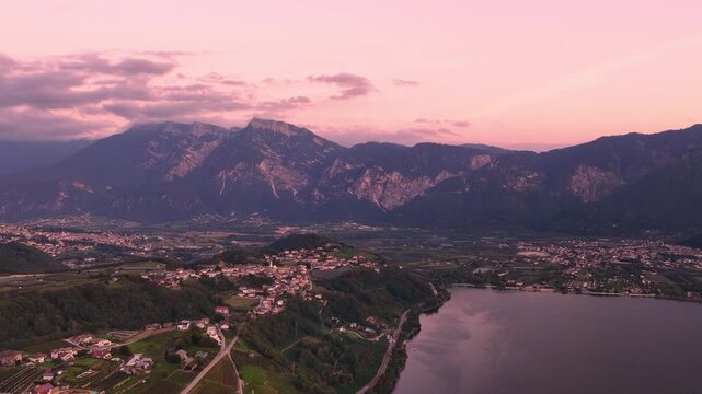 Tenna and Levico Terme beside a tranquil Alpine lake surrounded