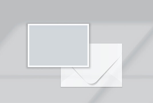 Blank postcard and envelope mockup on a soft background, featuring a minimal layout with realistic shadows for stationery branding, invitation design, wedding cards, gift card and print presentation