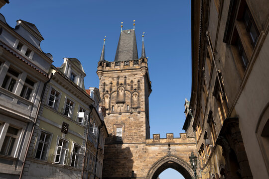 The Lesser Town Bridge Tower stands in Prague under a blue sky