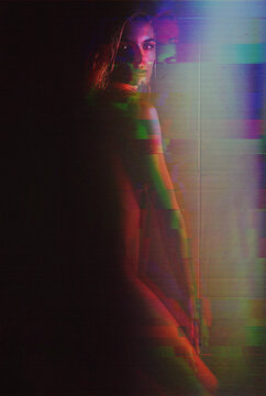 Woman displays a pixelated glitch effect in the dark metaverse