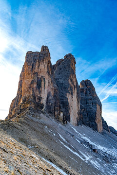 Tre Cime di Lavaredo mountain peak stands under a blue sky in Italy