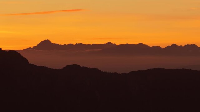 Sunset over the Dolomites with layered mountain ridges