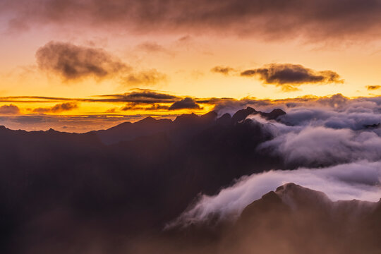 Foggy mountains at Miradouro da Bica da Cana before sunrise in Madeira