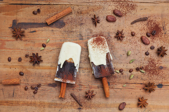 Homemade coffee and white chocolate ice lollies with winter spices, decoration