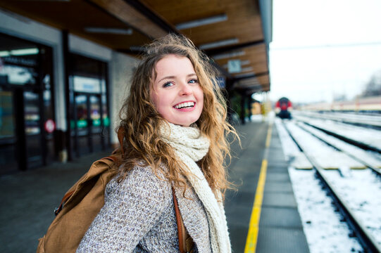 Smiling teenage girl on station platform