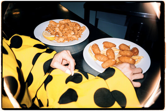 Woman in flamenco dress eating traditional Spanish tapas