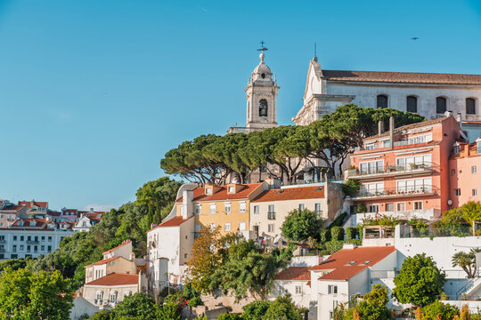 Historic architecture stands on a sunny hill in Lisbon, Portugal