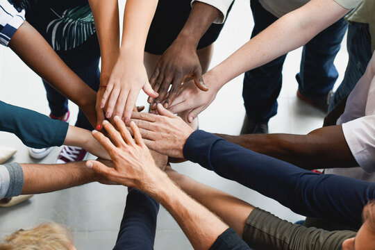 Diverse hands united in teamwork and collaboration
