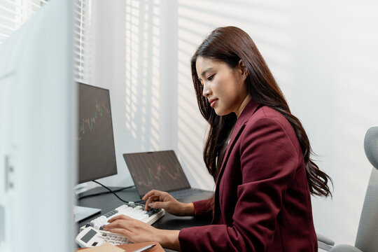 Financial analyst monitoring market trends and investment performance in modern office, representing stock trading, technical analysis, portfolio management and professional financial decision making.