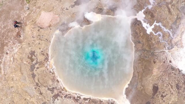 Flying above the Great Geyser, geysir in the Golden Circle, Iceland, slow motion aerial view