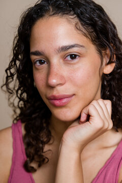 Close-up portrait of Hispanic woman with natural skin and curly hair