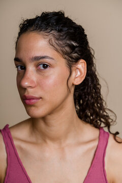 Hispanic woman portrait with curly hair and natural skin