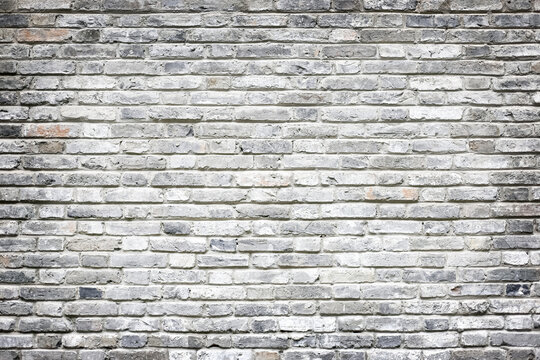 Grey and white whitewashed brick wall texture background in industrial loft style