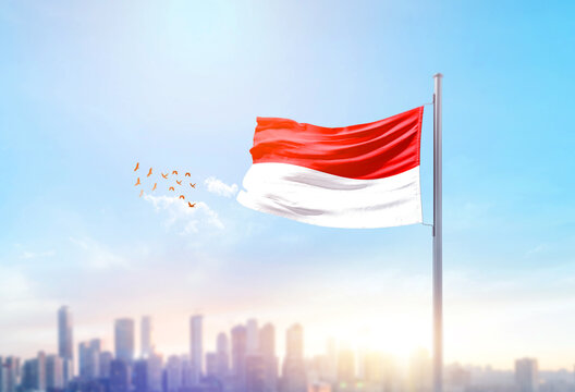 Indonesia national flag waving with skyline and buildings. Indonesia national flag for independence day.